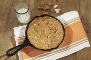 Salted Caramel Crunch Skillet Cookie is hand-mixed with browned butter, white chocolate, pretzel bites, sea salt and HEATH toffee pieces. With pretzel salt and demerara sugar atop, each bite is dangerously better than the last.