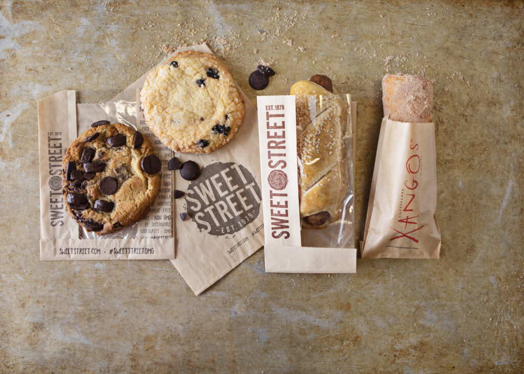 2 cookies, handcrafted pretzels and Xango in to-go bags.