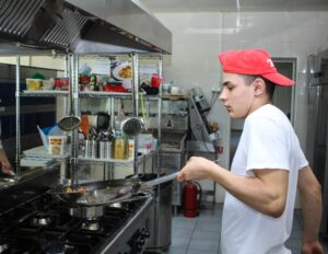 Image of Young Man working in kitchen